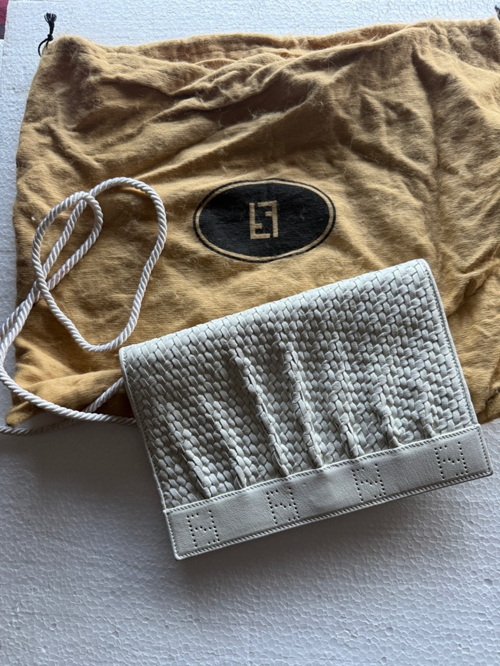 Vintage Fendi flap bag with braided cord shoulder strap. White worn with dustbag